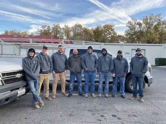 The Kim Persson Electric crew in front of their vans